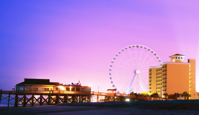 Ferris wheel and pier at dusk.