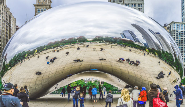 Close up view of large mirrored sculpture in the city.