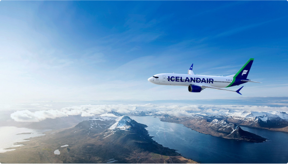 Icelandair aircraft flying over mountainous terrain